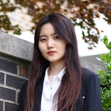 woman in front of brick wall